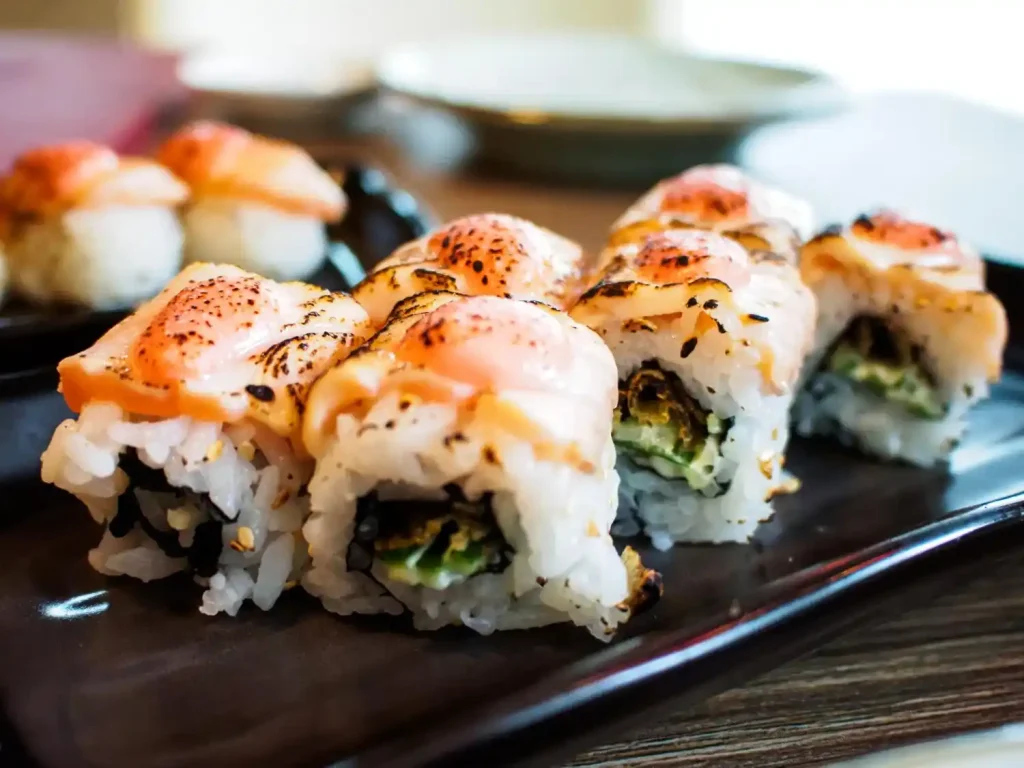 Sushi, prato japonês frio Sushi tradicional com arroz, peixe e recheio cremoso, finalizado com cobertura levemente grelhada.